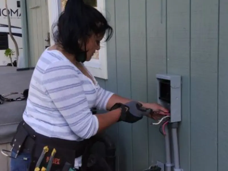 Licensed electrician wiring an exterior subpanel in Morehead